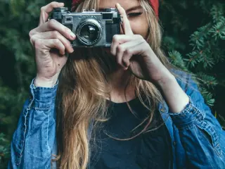 Woman holding a vintage camera